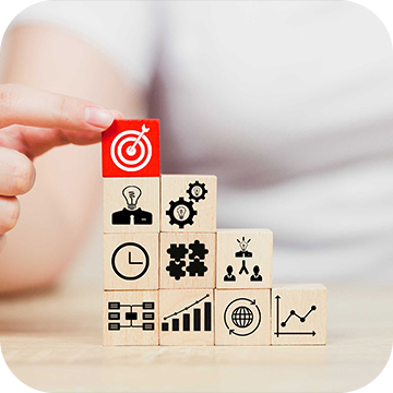 Growing Business person placing blocks with different symbols on them