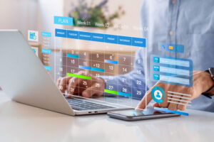 An individual using a laptop with a holographic display of a weekly calendar and task list in a modern workspace. The interface shows scheduled tasks for various projects, with a clean and futuristic design, possibly for managing professional deadlines.