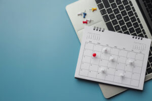 Embroidered red pins on a calendar event