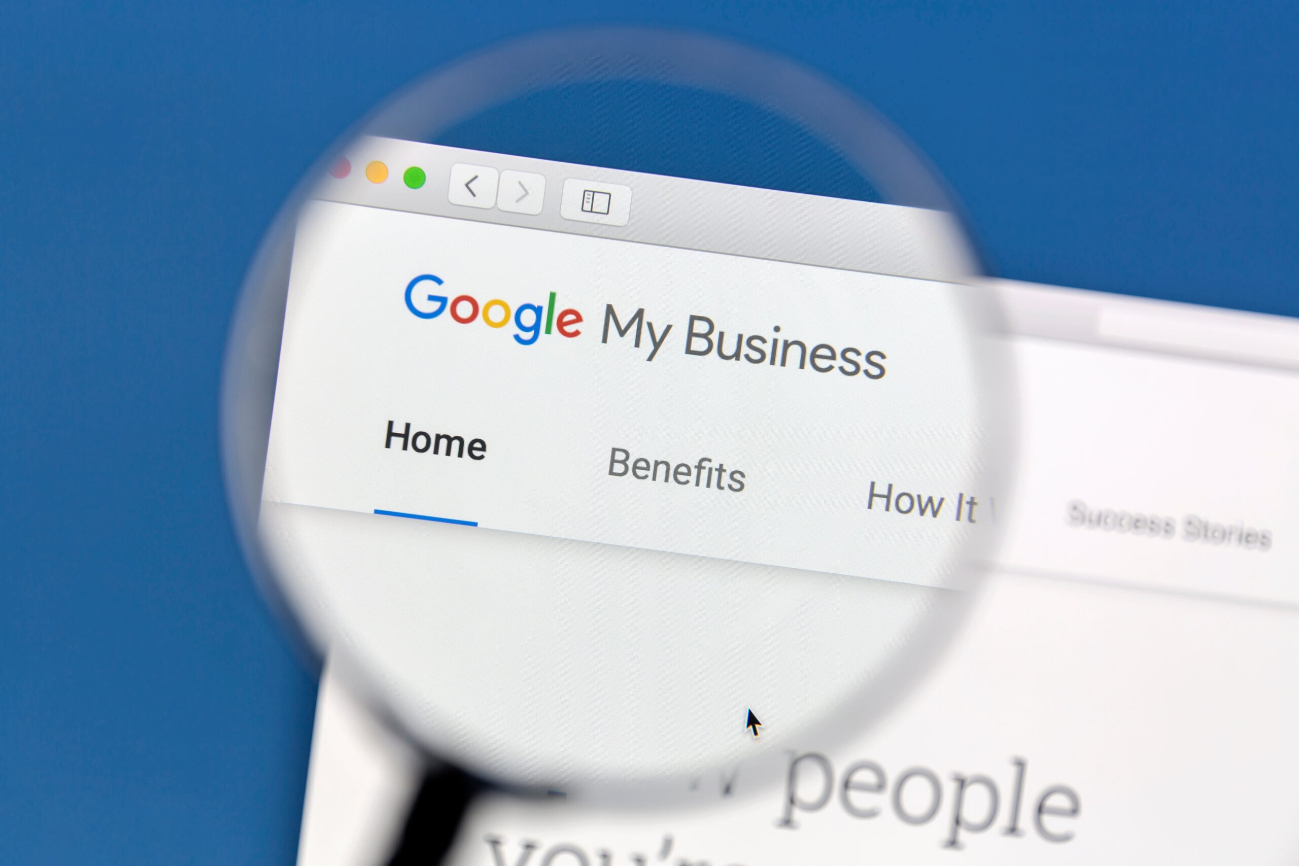 Magnifying glass focusing on the Google My Business webpage header in a browser.