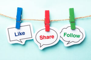 Like share follow bubble with clip hanging on the line with blue background.
