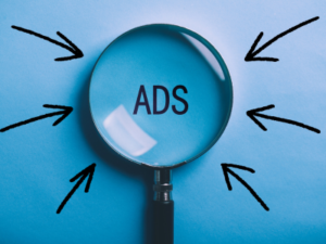Magnifying glass with word Ads and arrows.