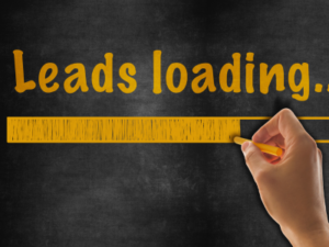 Person writing with chalk words: leads loading.