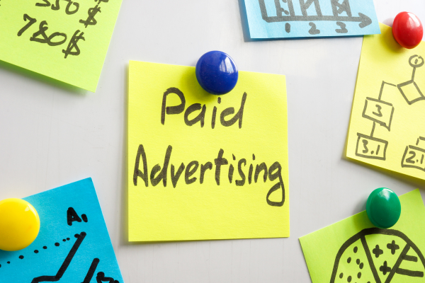 Sticky note with words paid advertising.